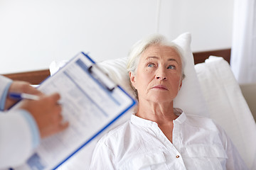 Image showing doctor visiting senior woman patient at hospital