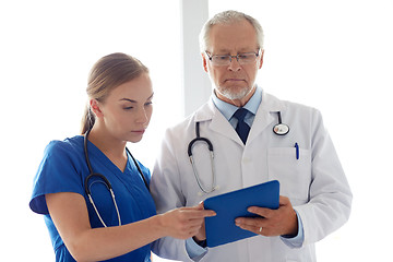 Image showing senior doctor and nurse with tablet pc at hospital