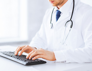 Image showing male doctor typing  on the keyboard