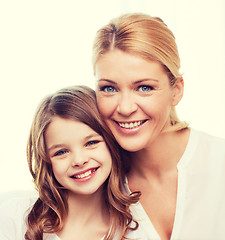 Image showing smiling mother and little girl at home