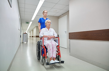 Image showing nurse with senior woman in wheelchair at hospital