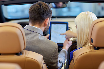 Image showing couple sitting in cabriolet car with tablet pc