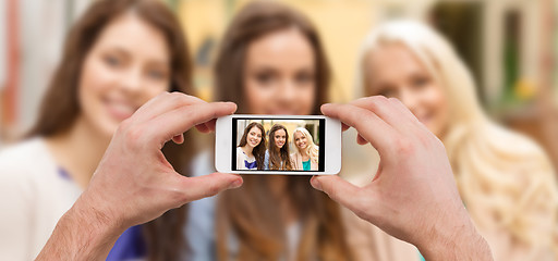 Image showing close up of hands taking picture with smartphone