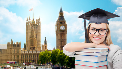 Image showing student in trencher cap with books over london