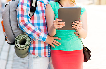 Image showing couple with tablet pc and backpack in city