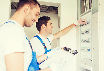 Image showing builders with clipboard and electrical panel