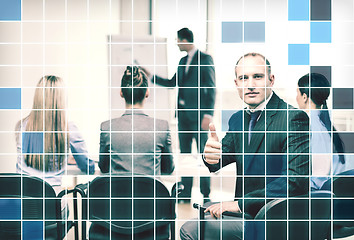 Image showing businessman with team showing thumbs up in office