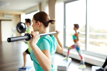 Image showing close up of people exercising with bars in gym