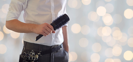 Image showing close up of male stylist with brush at salon