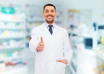 Image showing smiling pharmacist showing thumbs up at drugstore