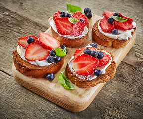 Image showing toasted bread with berries and cream cheese