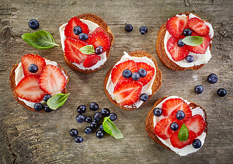 Image showing toasted bread with berries and cream cheese