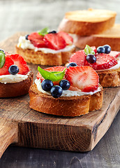 Image showing toasted bread with berries and cream cheese