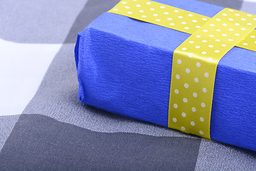 Image showing blue gift box with yellow ribbon