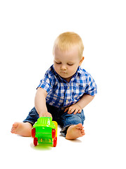 Image showing little boy with toys on a white background