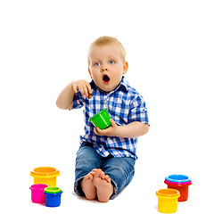 Image showing little boy with toys on a white background