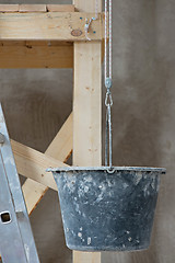 Image showing Dirty bucket and ladder on wall background