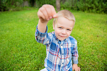 Image showing Happy little boy showing something