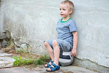 Image showing Boy sitting on a ball