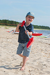 Image showing Young boy playing with sand