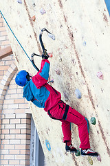 Image showing Man climbs upward on ice climbing competition