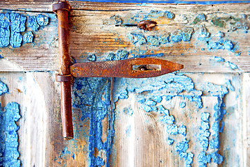 Image showing rusty metal    dirty stripped paint in the   morocco knocker