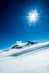 Image showing Sun and snowy mountain.