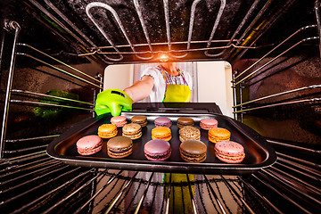 Image showing Baking macarons in the oven.