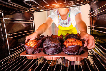 Image showing Baking muffins in the oven