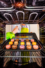 Image showing Baking macarons in the oven.