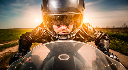 Image showing Biker racing on the road