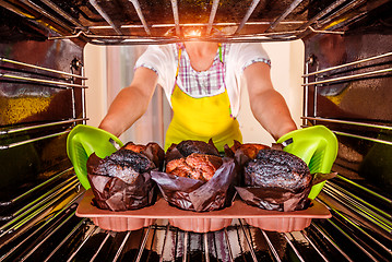 Image showing Baking muffins in the oven