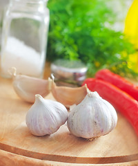 Image showing Fresh garlic and aroma spice on the wooden board