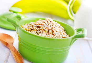 Image showing Oat flakes in the green bowl with banana and milk