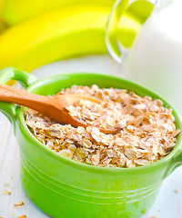 Image showing Oat flakes in the green bowl with banana and milk