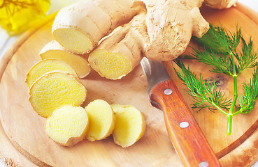 Image showing Fresh ginger and knife on the wooden board