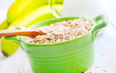 Image showing Oat flakes in the green bowl with banana and milk