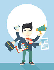 Image showing Young but happy japanese employee doing multitasking office tasks.