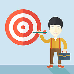 Image showing Working chinese man holding a target arrow 