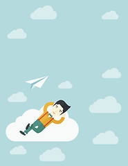 Image showing Asian man lying on a cloud with paper plane.