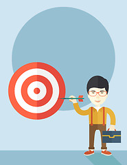 Image showing Working chinese man holding a target arrow 