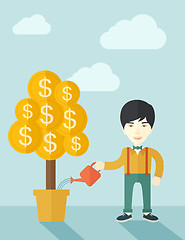 Image showing Asian businessman happily watering the money tree.