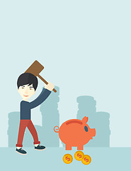 Image showing Chinese guy holding a hammer breaking piggy bank.