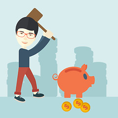 Image showing Chinese guy holding a hammer breaking piggy bank.