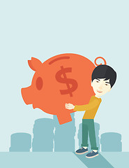 Image showing Chinese businessman carries a big piggy bank for saving money.