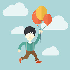 Image showing Young japanese man flying with balloons.