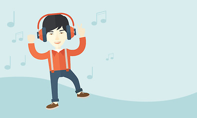 Image showing Happy young man dancing while listening to music.