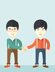 Image showing Two asian guys happily handshaking.