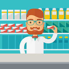 Image showing Young  pharmacy chemist man standing in drugstore. 
