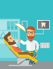 Image showing Dentist man examines a patient teeth in the clinic